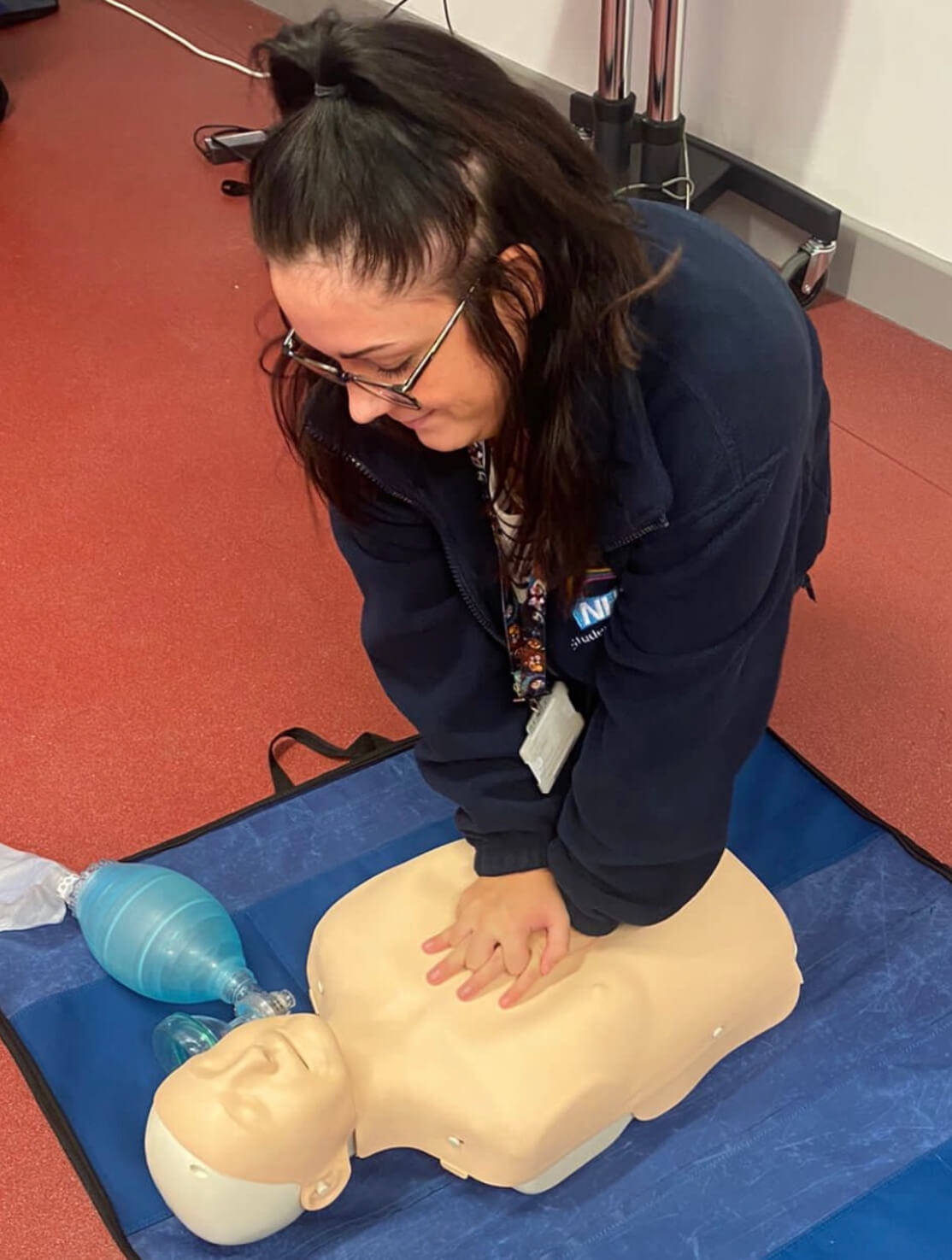 Student midwife Jaime performing CPR on a mannequin