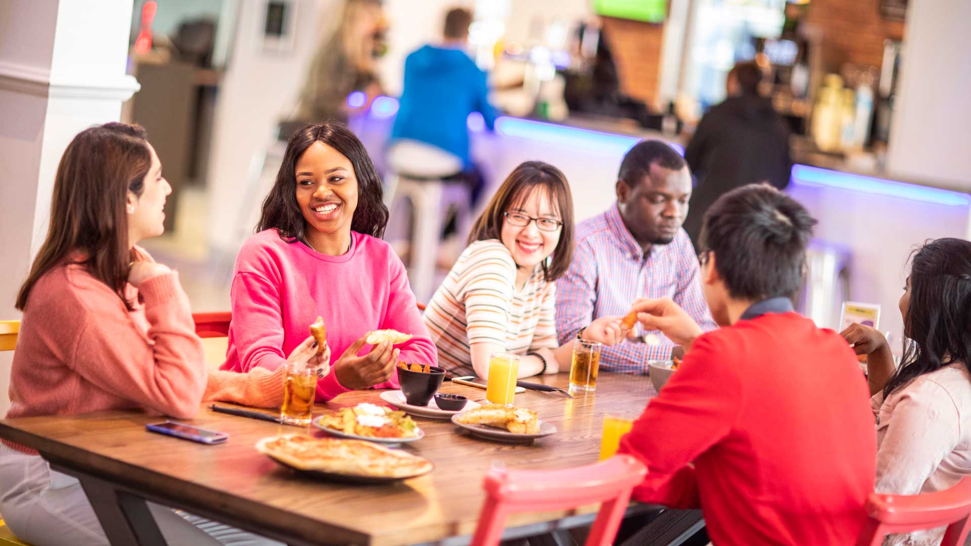 Six students having lunch and socialising