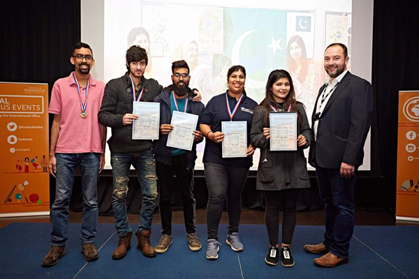 A group photo of students holding up certificates.