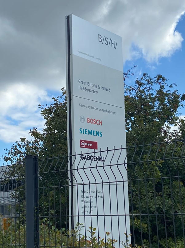 A sign outside BSH Home Appliances showing the brands the company produces