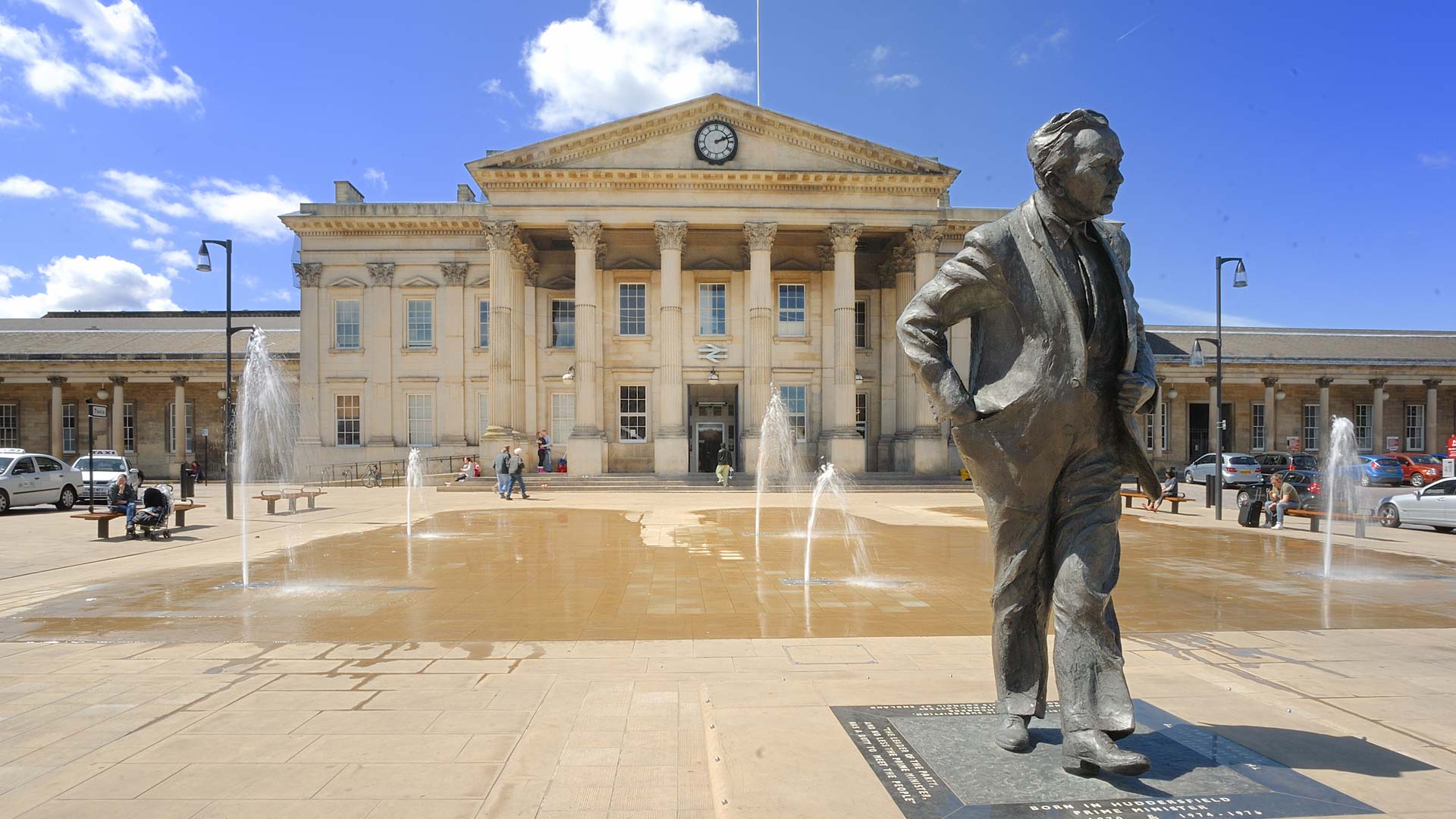 Picture of the Harold Wilson statue outside the Huddersfield train station.