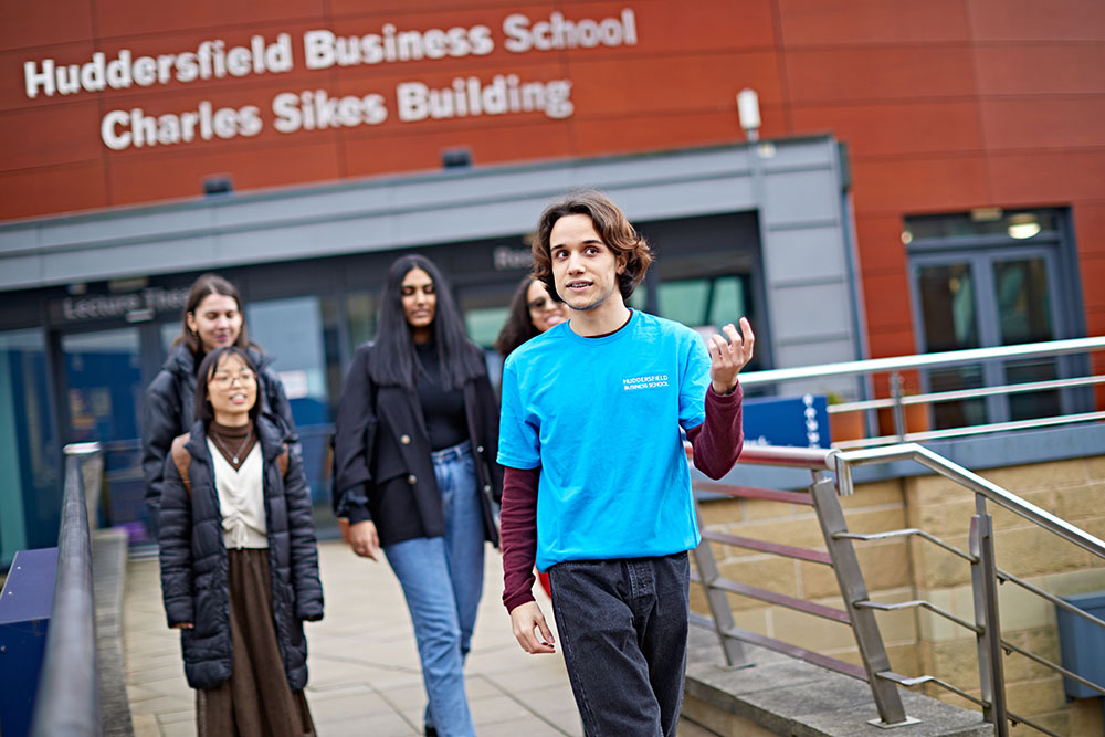 Students having a campus tour outside the business school