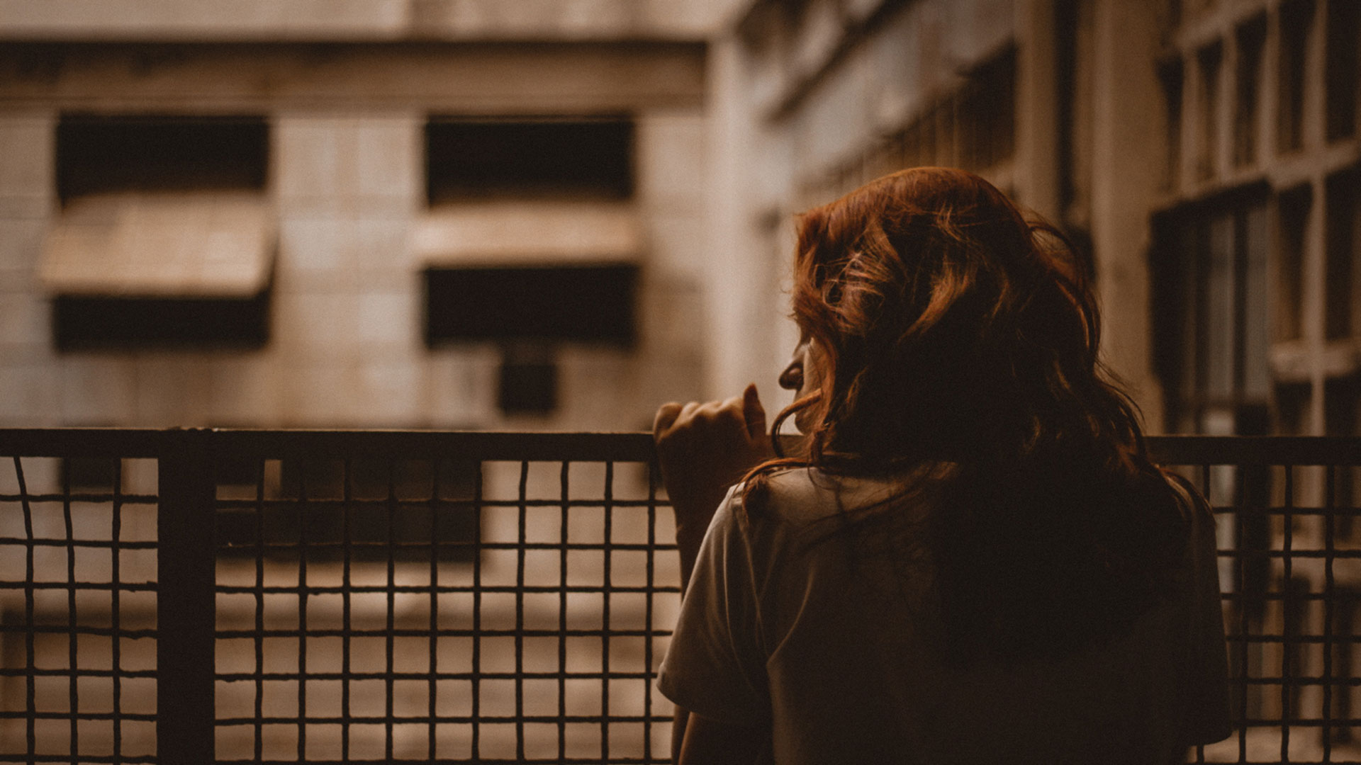 Young woman looking out over balcony