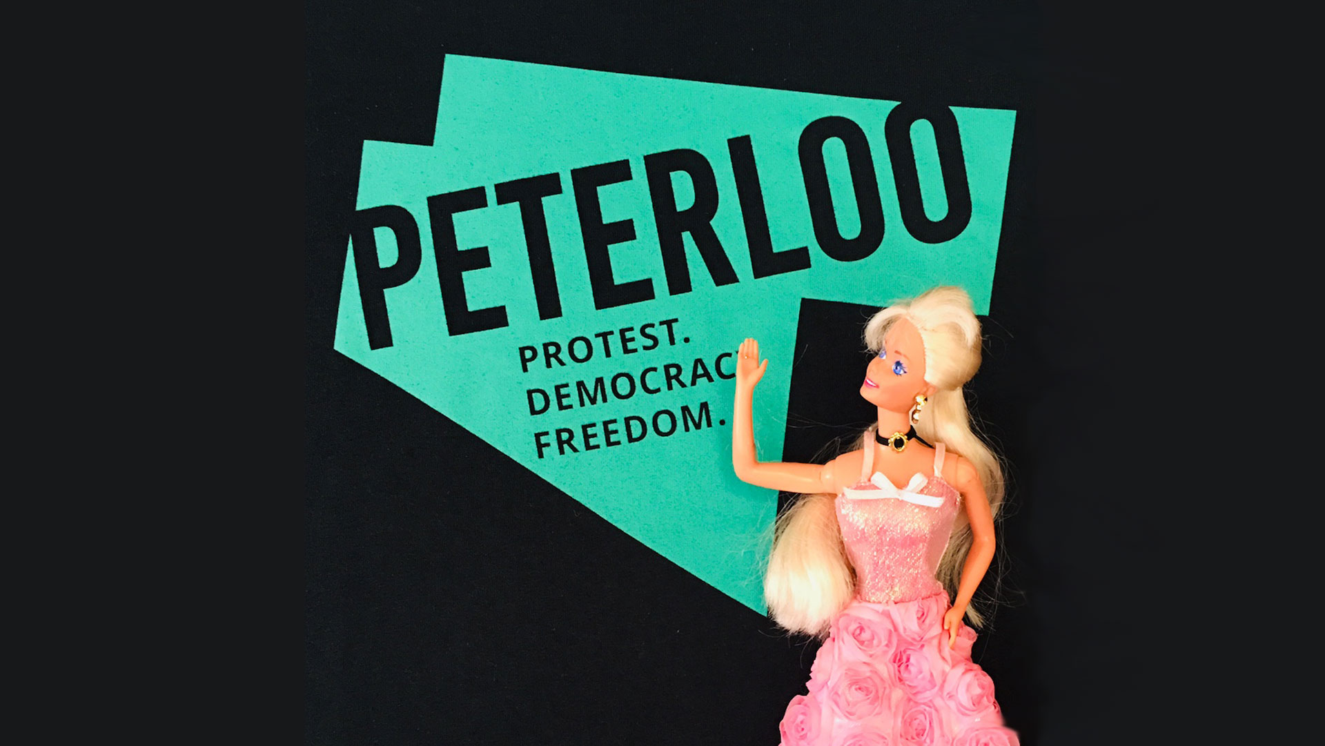 Barbie doll posed before poster reading Peterloo, Protest, democracy, Freedom