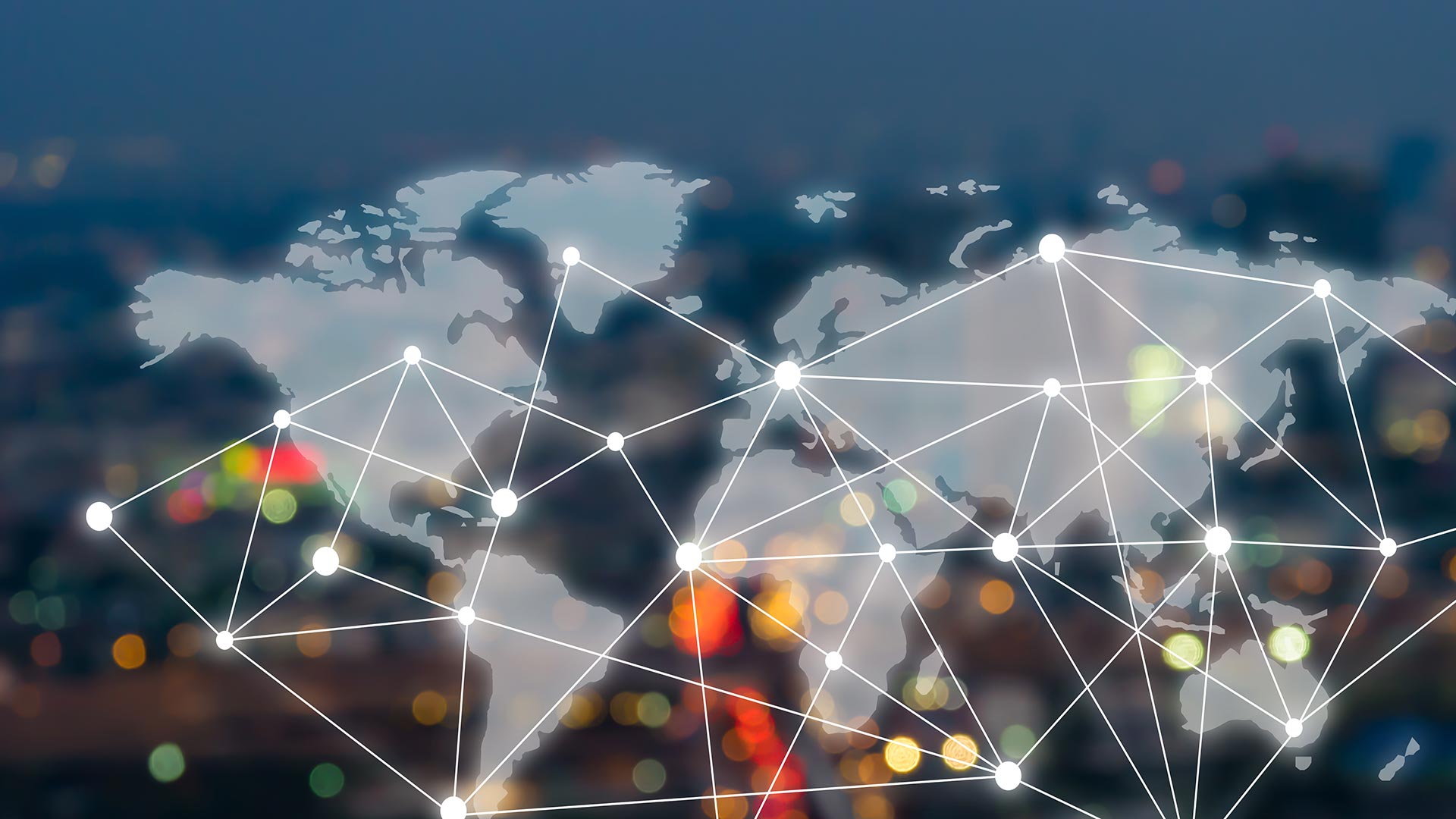 Abstract graphic including world map with a network of lines connecting locations, over a cityscape of lights at night