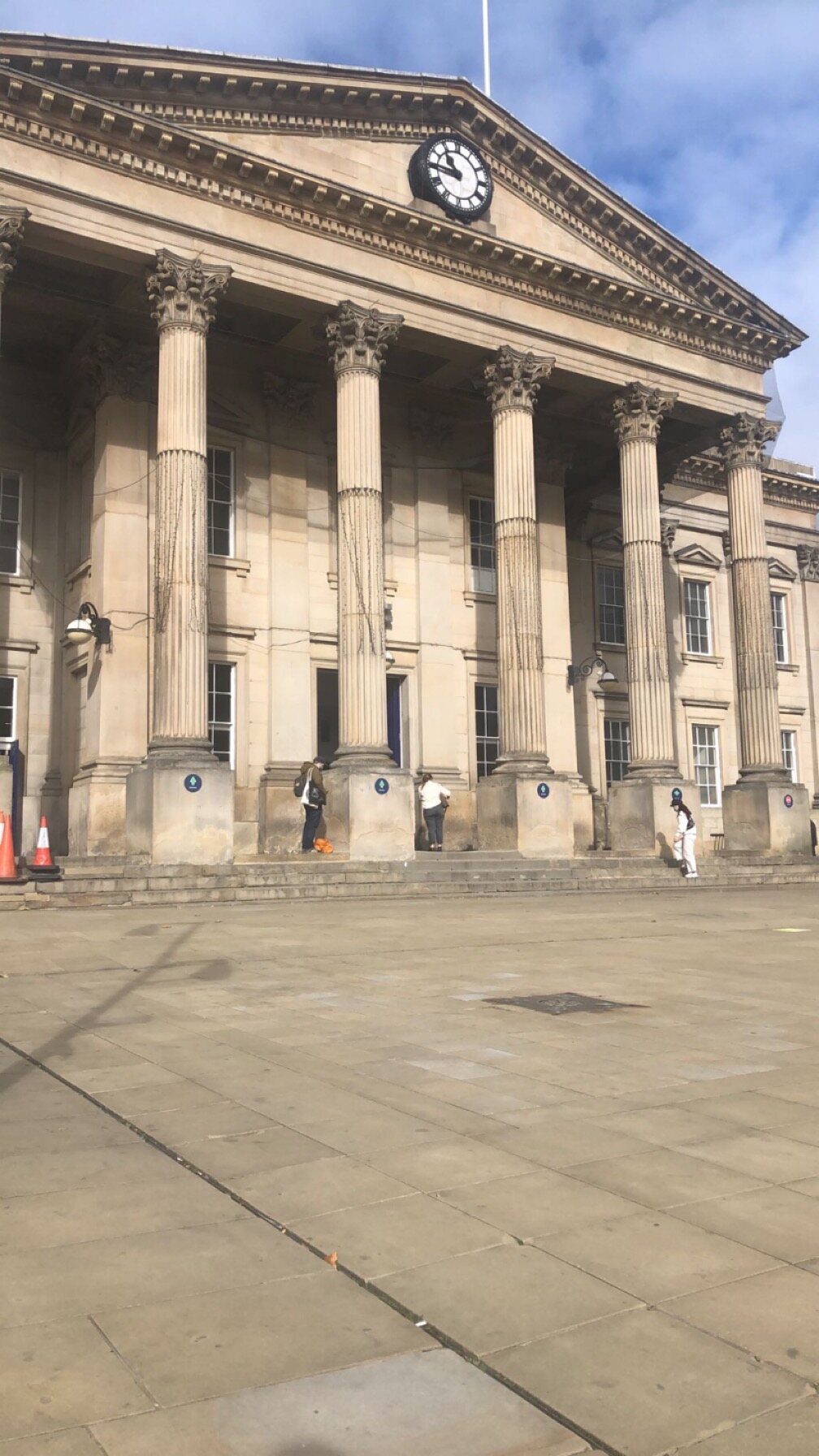 A view of the neo-classical Huddersfield Railway Station building in St George's Square with stone columns