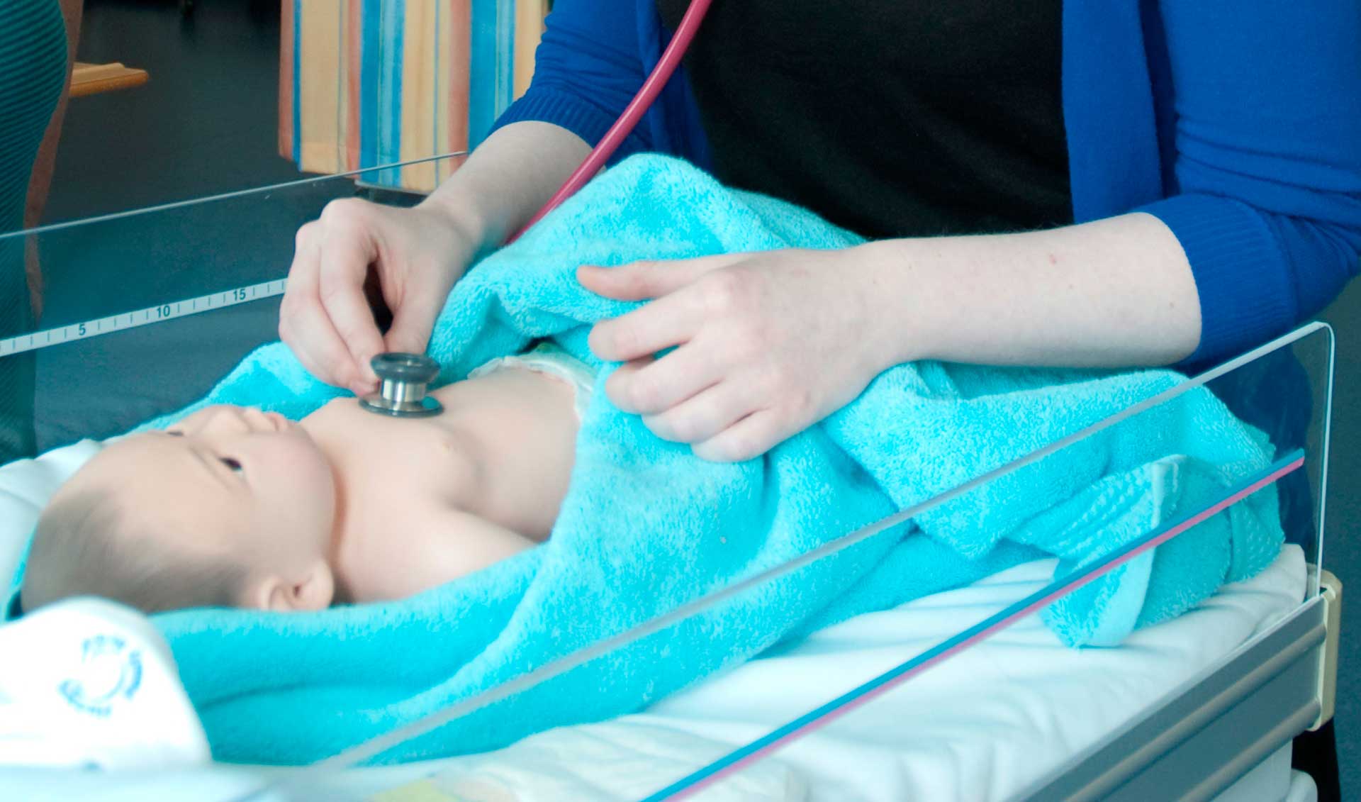 Student midwife assessing neonatal wellbeing