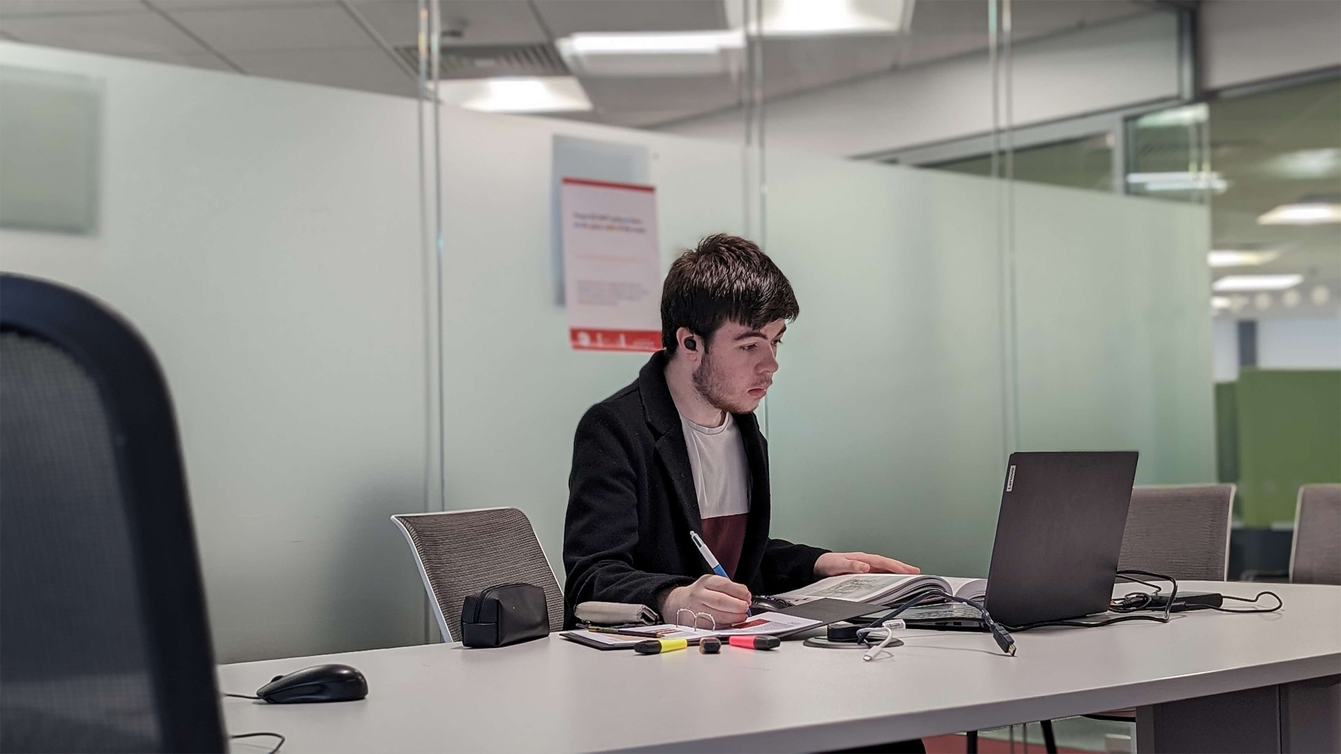 computer science student John Reid studying in the library