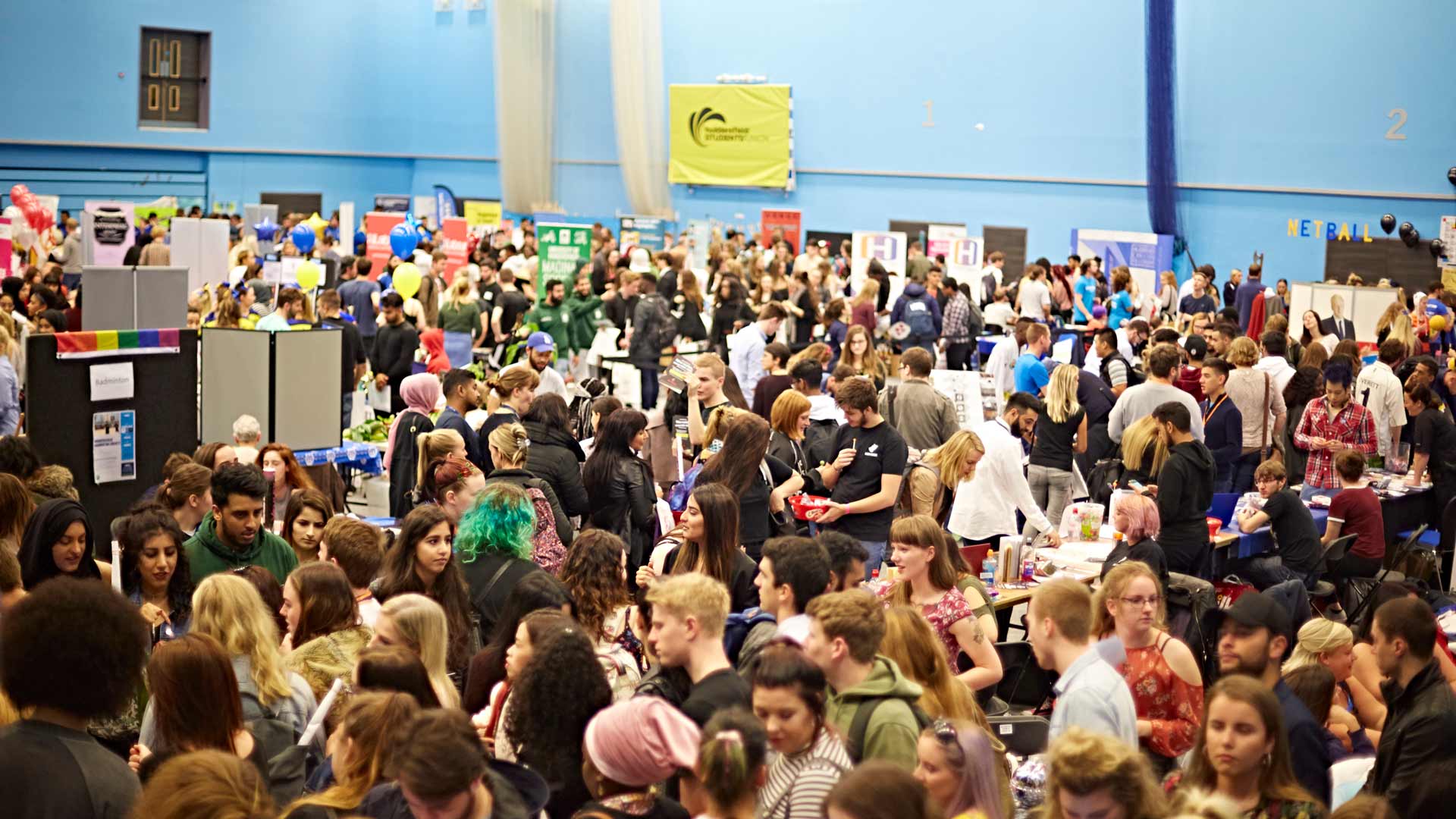 Sports hall full of students during freshers week.