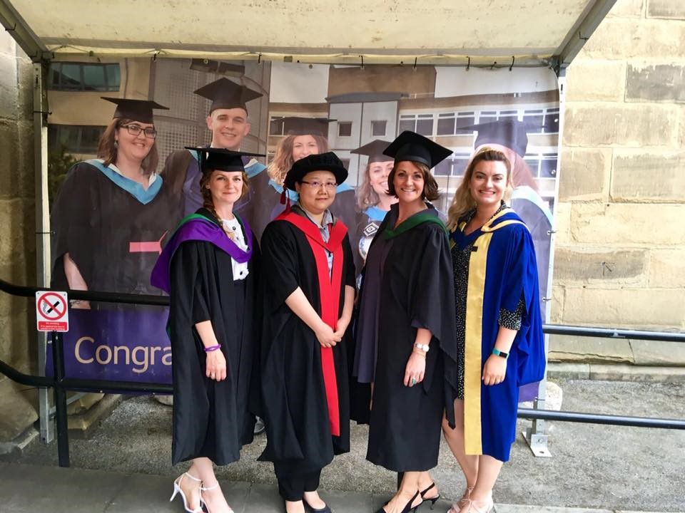 A photo of Nikki Dawson posing with three other women at a ceremony.