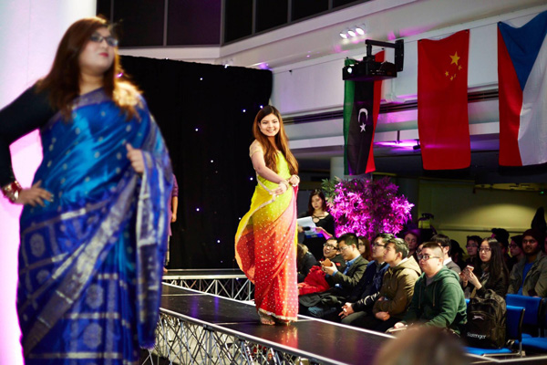 A fashion show event showing off colourful asian dresses