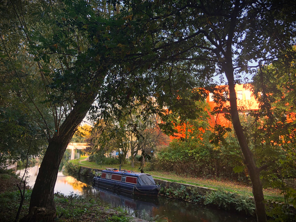 A picture of the canal next to the university of huddersfield with a canal barge on it