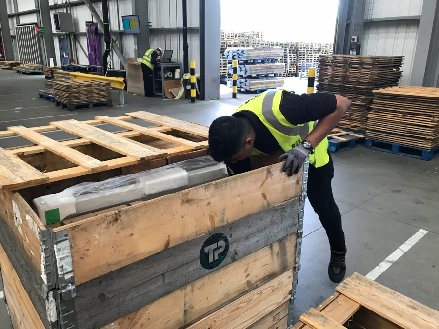 A photograph of Anasur Rahman working in a warehouse.