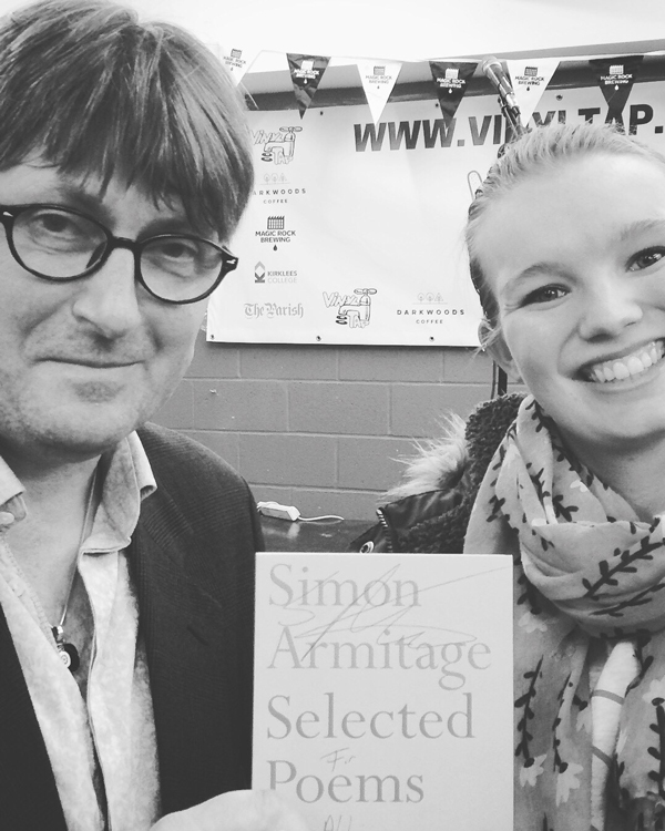 A picture of Abbi receiving an autograph from Simon Armitage!