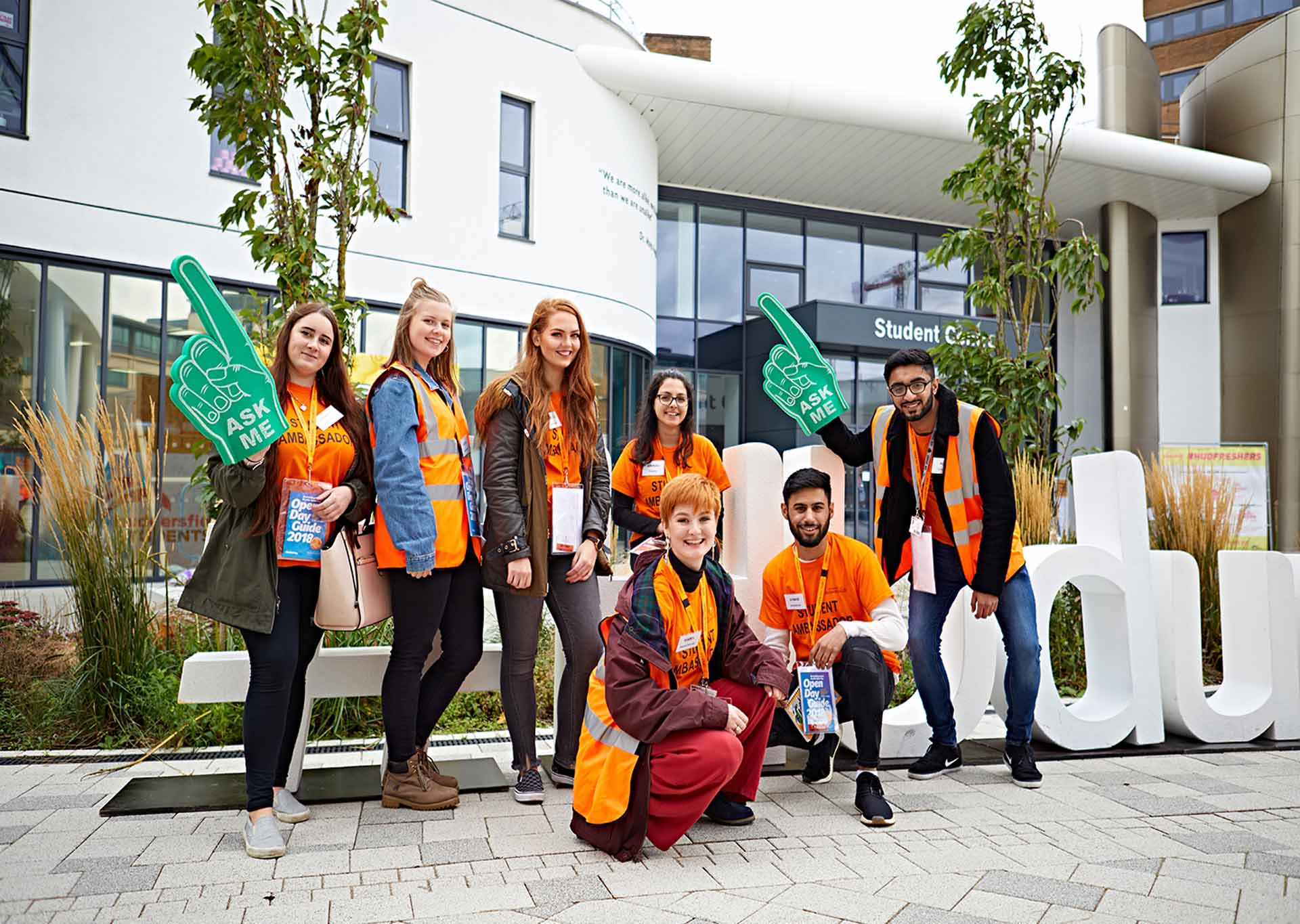 A group photo of seven student ambassadors posing with