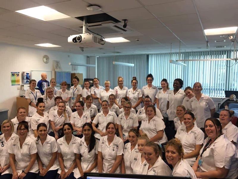 A group photograph of a cohort of Midwifery students.