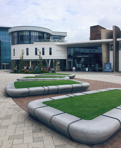 A photo of the grass patches on The University of Huddersfield campus plaza