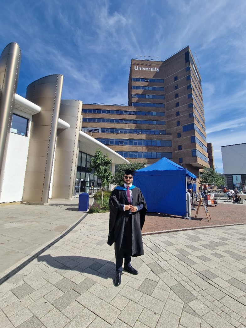 Huzaif in front of the main University building at graduation