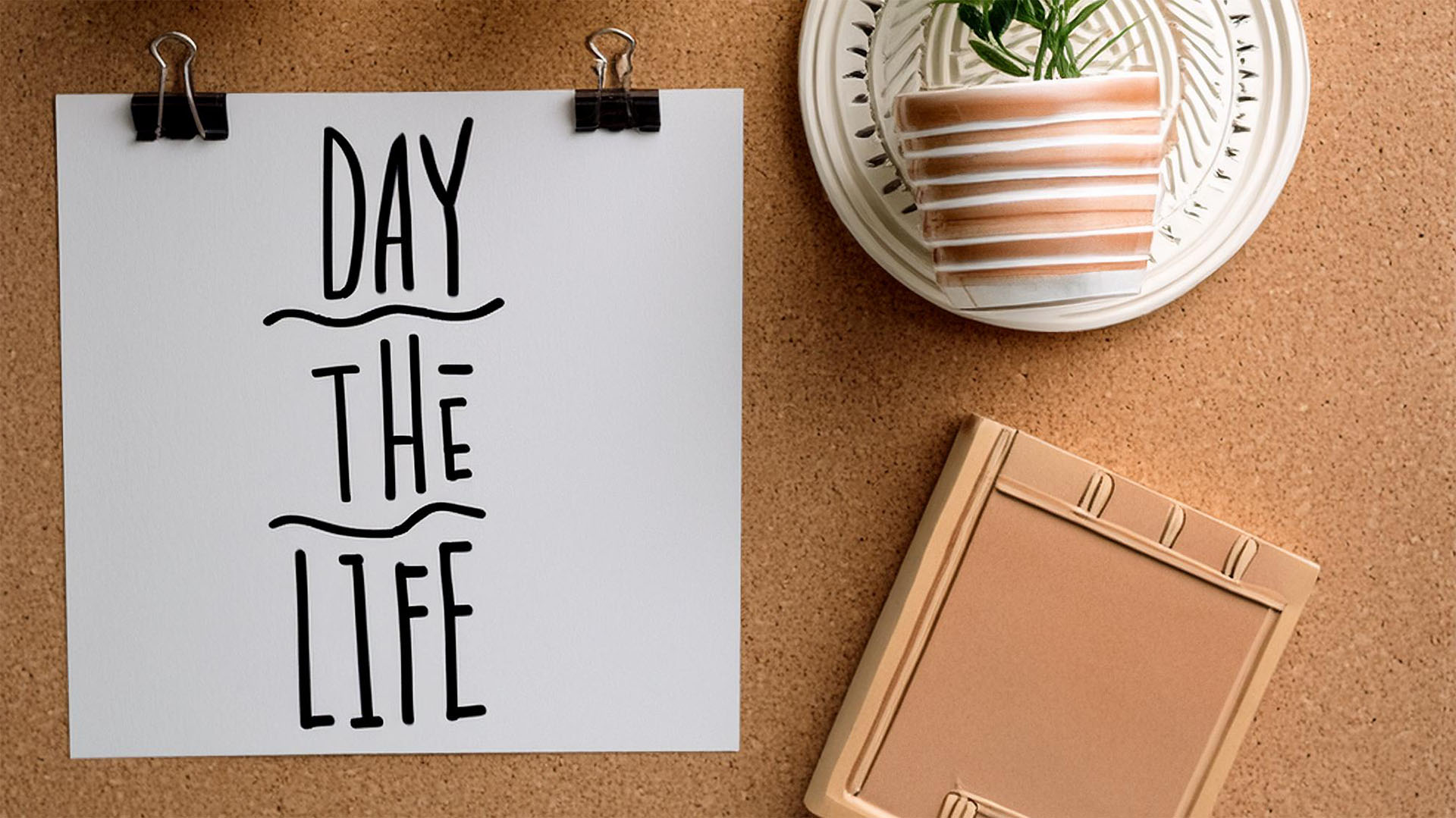 A pin board with various decorations on it, with a piece of paper reads 'day in the life'