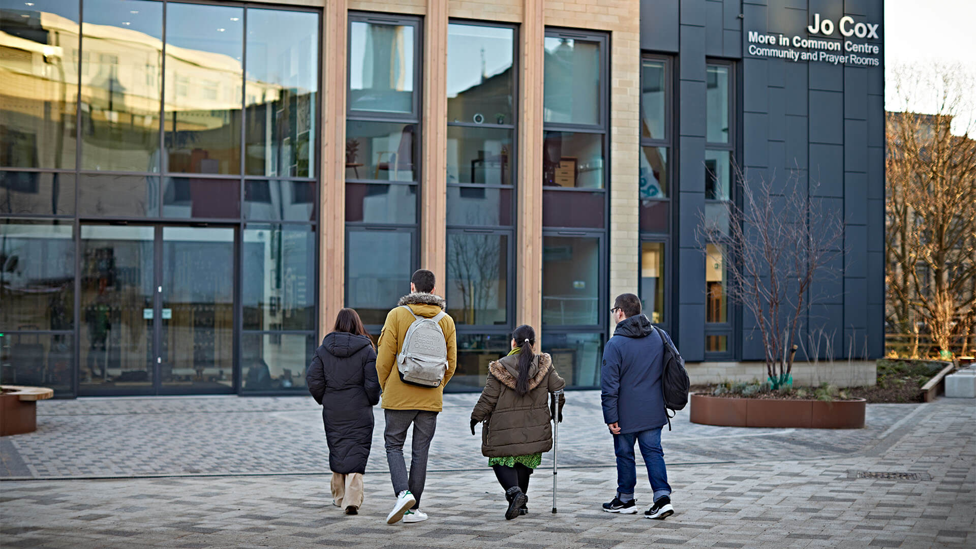 A group of disabled students walk towards the Jo Cox centre