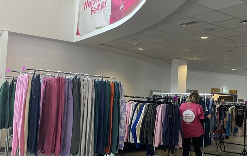 Rails of clothes at a student fashion sale