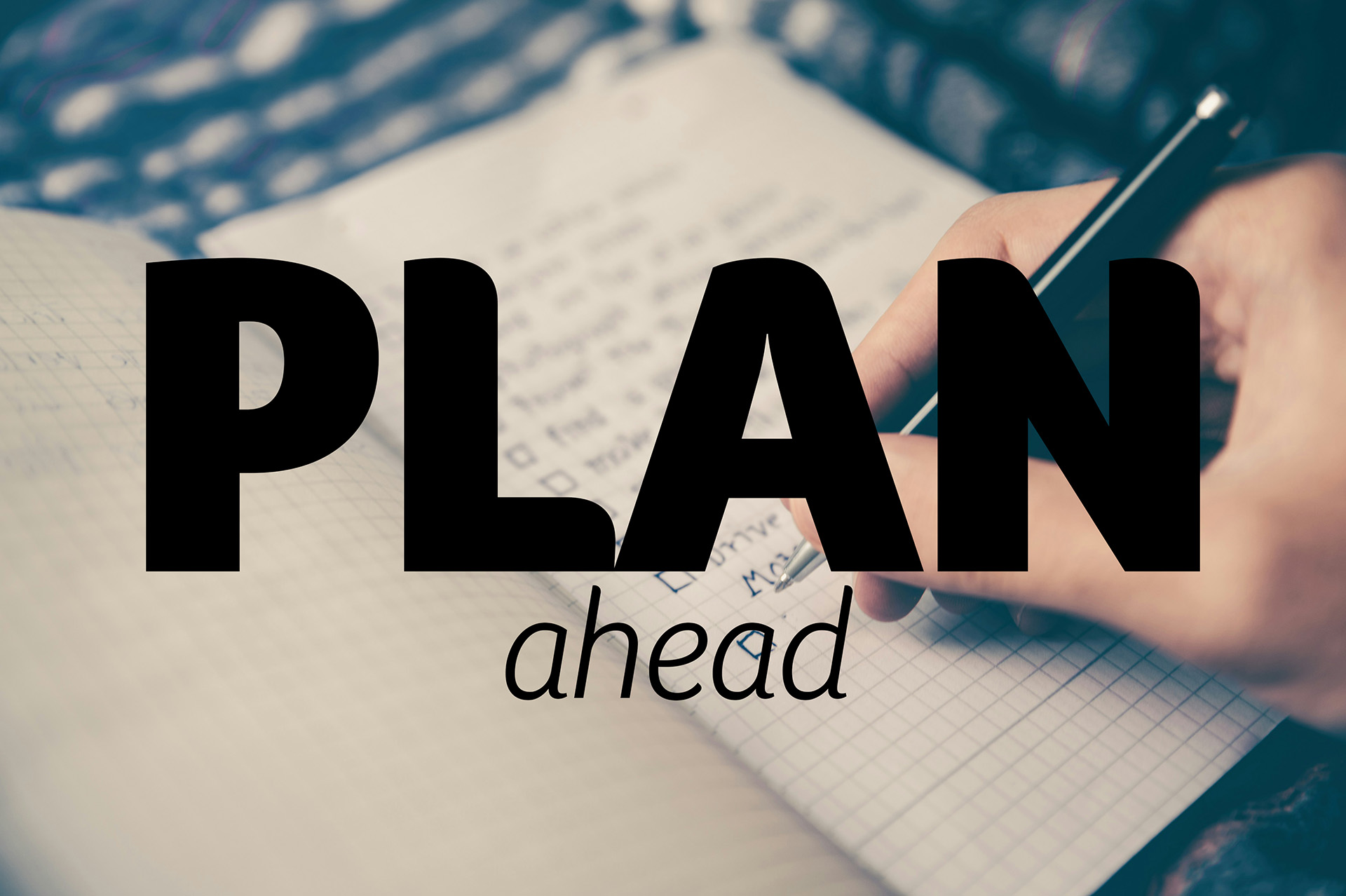 Photo by Glenn Carstens-Peters on Unsplash, a person wiriting in a notebook with the words plan ahead in large bold font overlayed