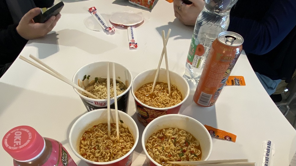 Four pots of ramen on a table