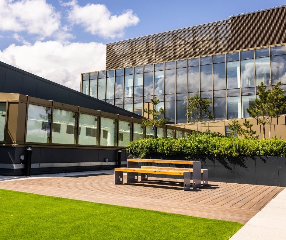 A terrace with grass and a seating area