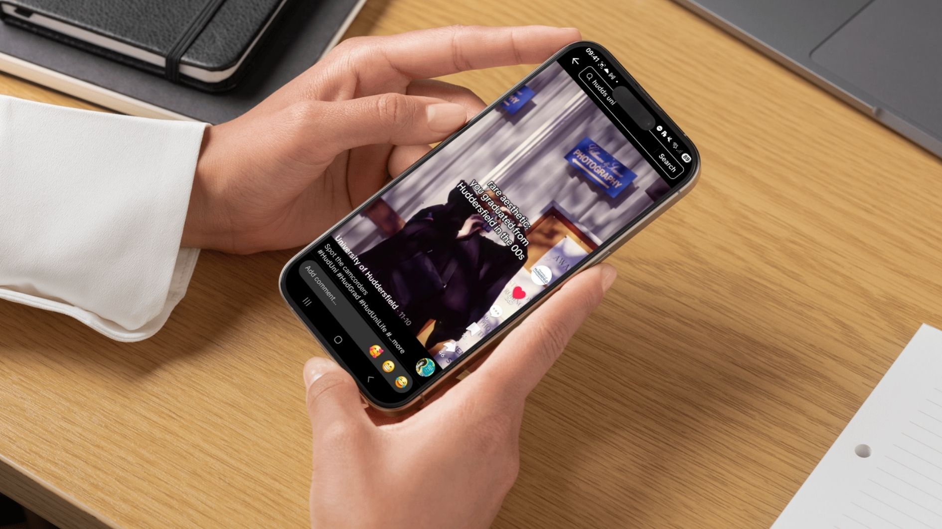 Hands holding a phone showing TikTok on the screen