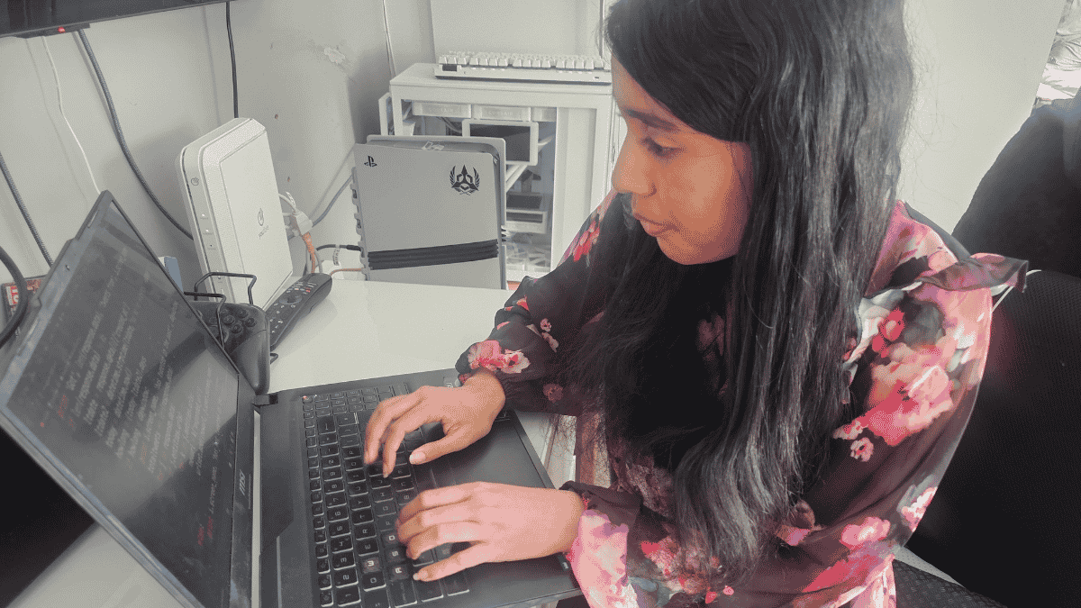 A student typing on a laptop