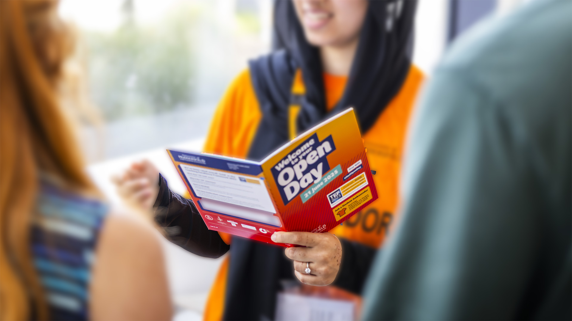 A person is holding a brochure titled