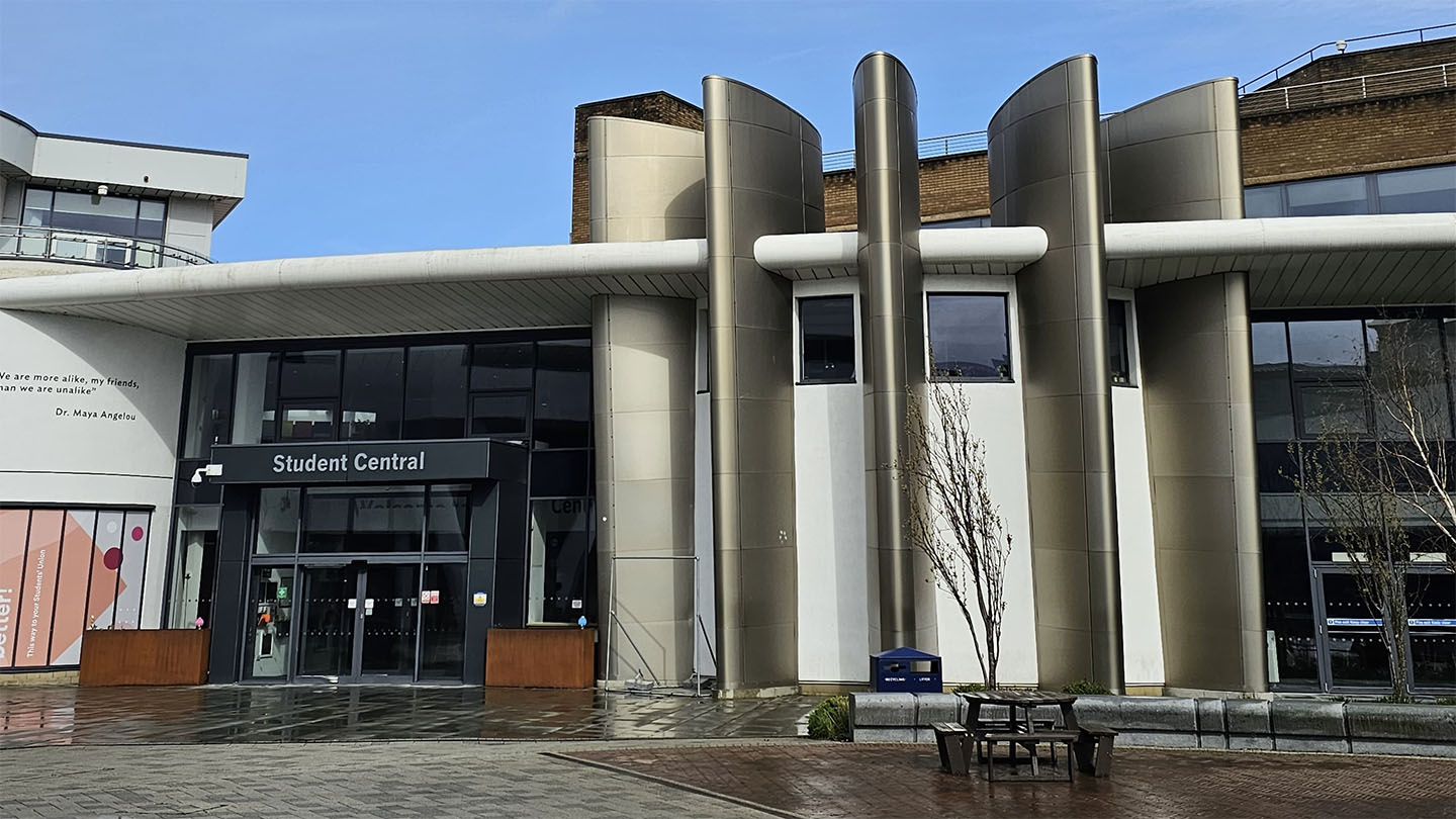 Contemporary building with large, cylindrical pillars and signage reading