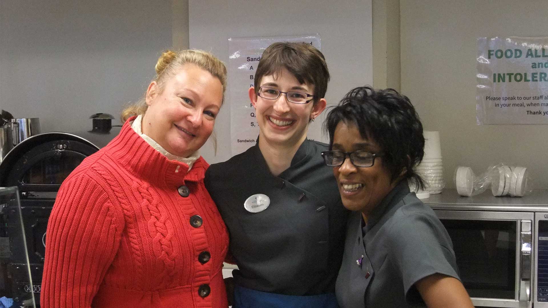 Elizabeth's last day in catering, taking photo with two colleagues