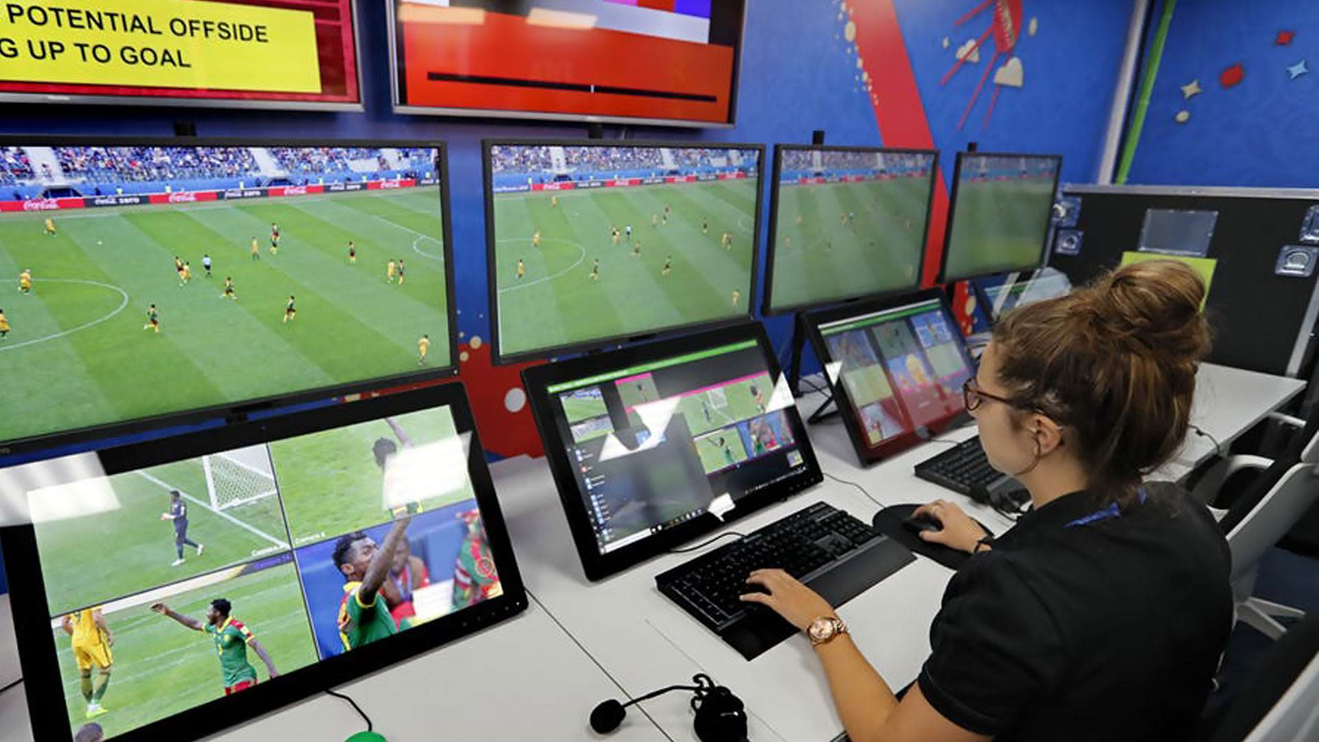 VAR referee watching a football match