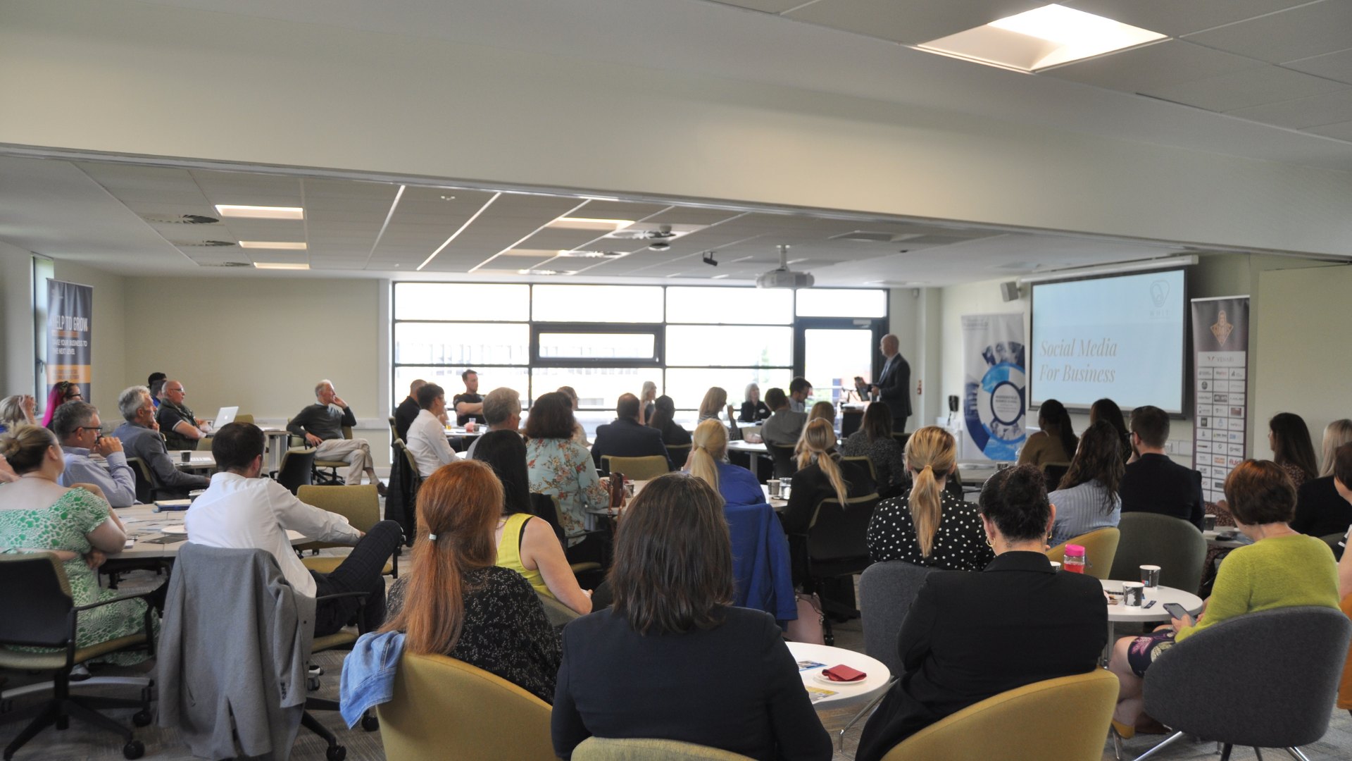 Business listening to Andrew Watson present