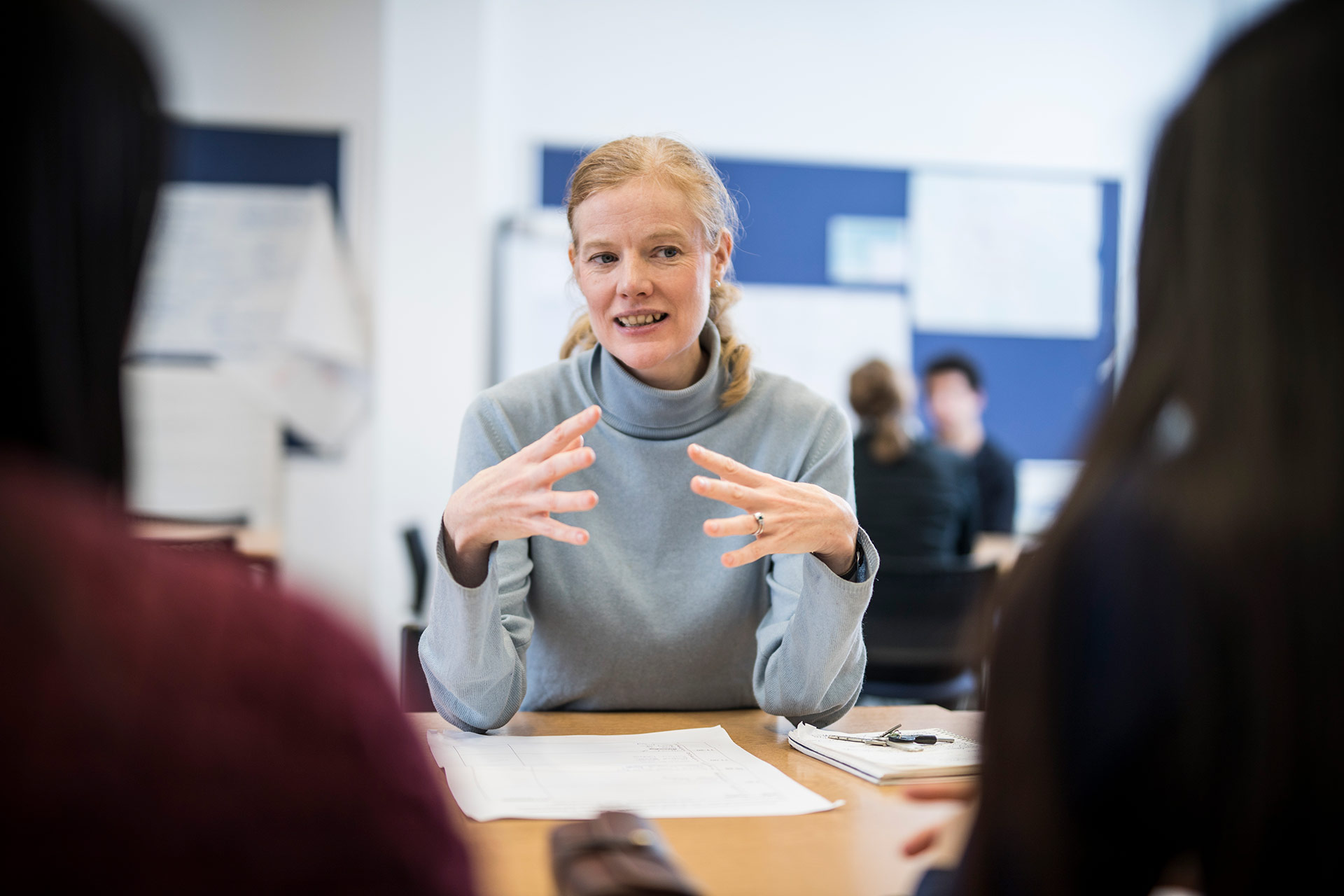 A Careers professional talking to two clients.