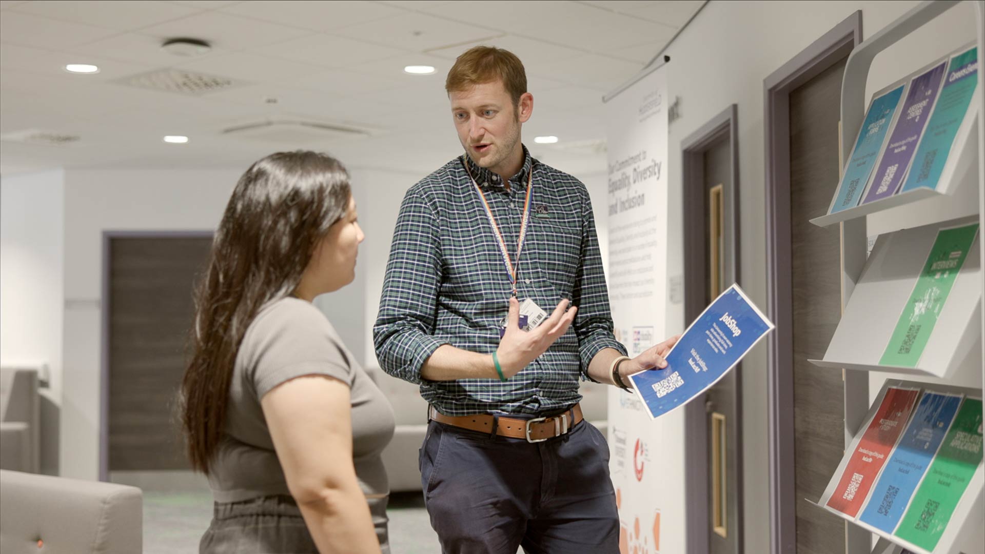 A Career Development Professional stood having a conversation with a client.