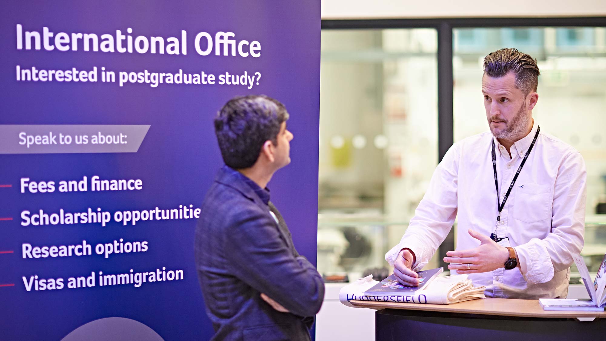 David chats to Hamid at the International Office stall at the Postgraduate Study Fair. 